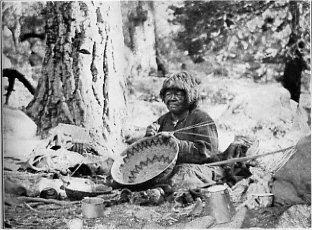 Kalapine, an old Yosemite Medicine Woman, making a coiled basket