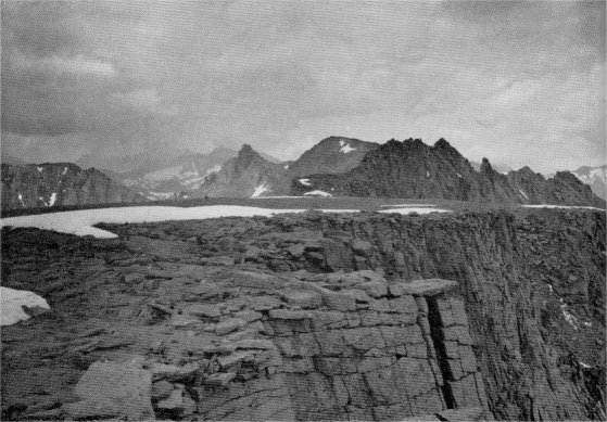 Table Mountain on the Great Western Divide, with its gently sloping tabular summit, represents the same ancient landscape surface as Mount Whitney and other summits on the Muir Crest, ten miles to the east. Milestone Mountain in the middle distance with the Red Spur on the skyline.