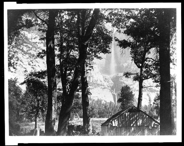 Trees and cabin with Yosemite Falls in background