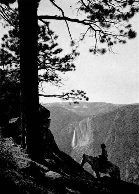 On the Glacier Point Trail one looks down upon the top of Yosemite Falls and up towards mountains higher. By Ansel Adams